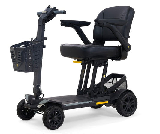 Golden Technologies Buzzaround CarryOn HD portable mobility scooter in black with red accents, front basket, padded swivel seat, adjustable armrests, and four-wheel base.